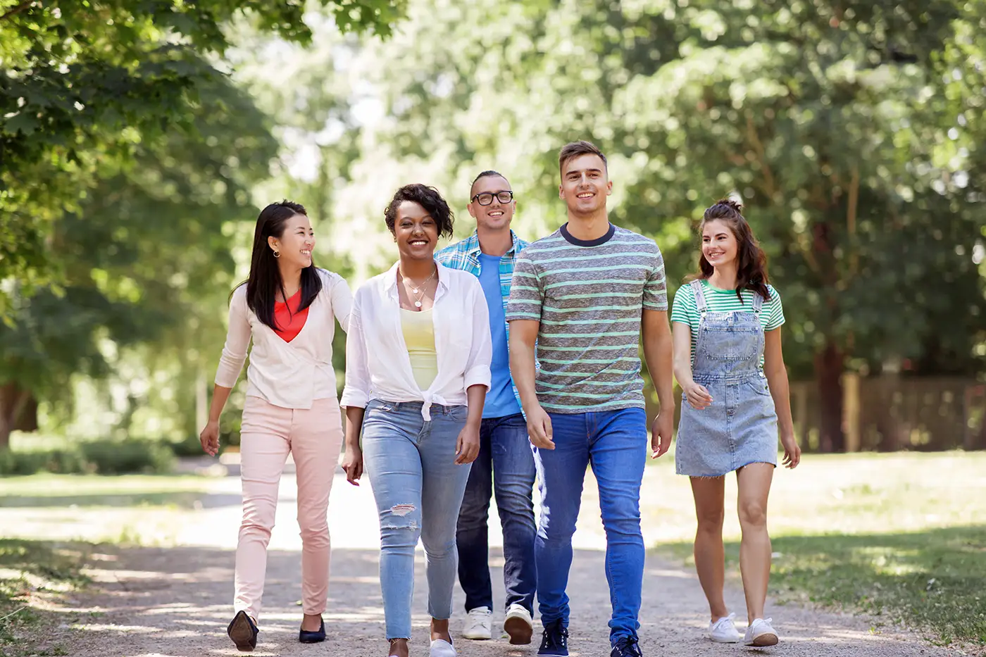 A group of young people walking in the park